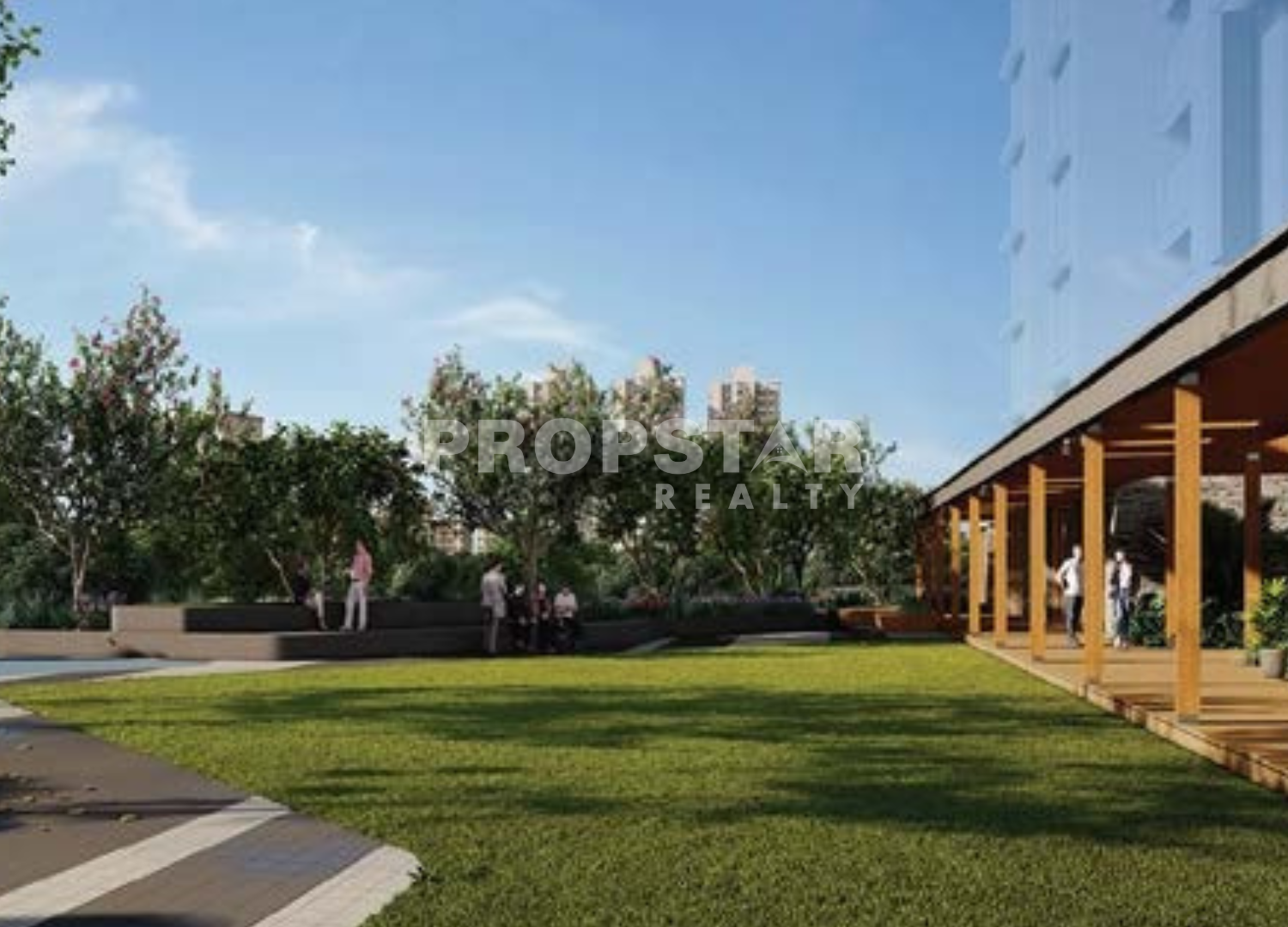 Outdoor community courtyard with manicured lawn, trees, and a wooden pergola building on the right; people strolling and relaxing.